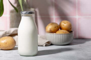 Bottle of potato milk on the table. Plant-Based Potato Milk Alternative, Vegan Milk