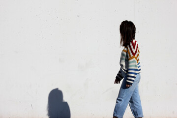 Girl in colored sweater on a white background