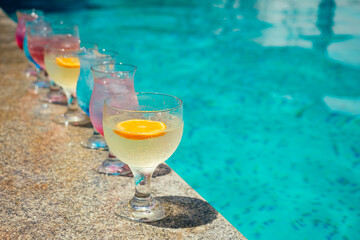 chers drinking cold lemonade in aquamarine swimmingpool