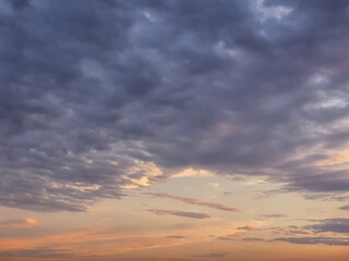 Sunset background with wonderful red,golden, yellow sky, Amazing purple and orange sky in evening during the sun going down above city.Dramatic sunset sky with clouds