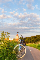 Bikes parked along the road towards light house De Ven in North-Holland in The Netherlands