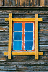 old routed vernacular window of a barn wall