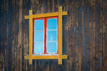 old routed vernacular window of a barn wall