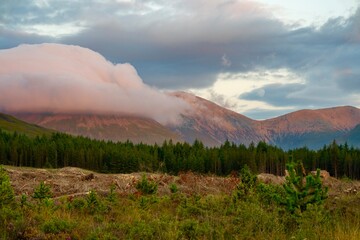 Fototapeta premium Sunset with beautiful colours on mountains and clouds in background 