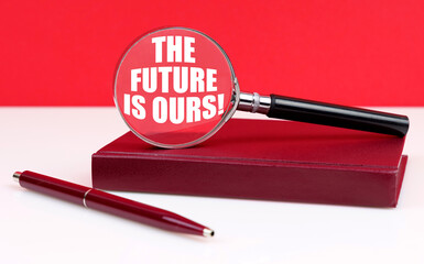 On a white and red background, a notebook, a pen and a magnifying glass, inside which the inscription The Future is Ours