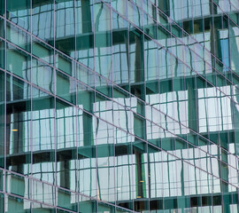 Fototapeta na wymiar Glass windows of facade modern building in Lisbon city, Portugal