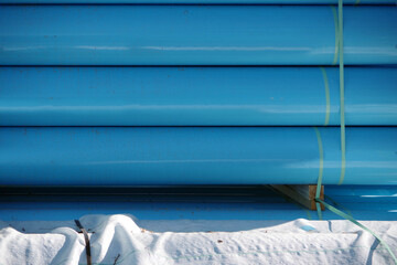 Full frame close-up view of stacked blue large main water pipes