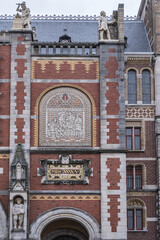 Obraz premium Architectural fragments of famous Rijksmuseum building (1885) in Amsterdam. Amsterdam Rijksmuseum holds many masterpiece paintings of Dutch and world art. Amsterdam, The Netherlands.