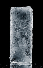 Textured natural ice block with cracks on a black reflective surface.