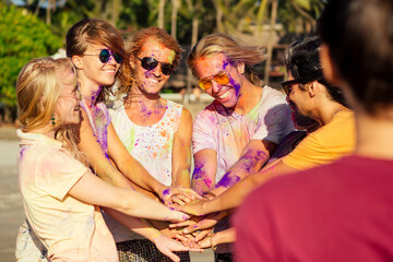 multinational multicultural mixed race friends in holi dust on beach in Goa