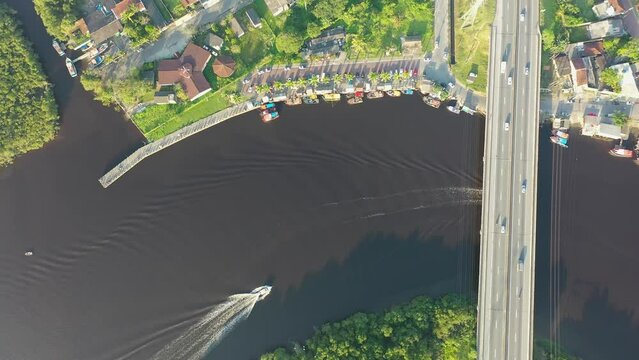 Panning wide view of peaceful darm river at coastal city of Itanhaem Sao Paulo Brazil. South coast of state of Sao Paulo. Tropical scenery. Travel destinations. Popular tourism landmark.