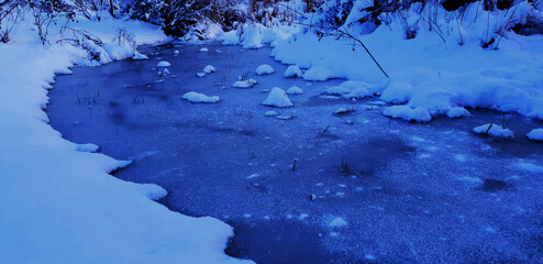 frozen stream under the snow 