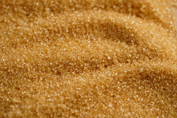 Brown unrefined cane sugar filling the frame, top view