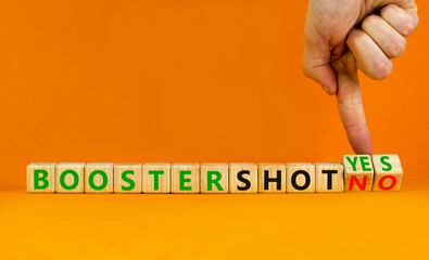 Covid-19 booster vaccine shot yes or no symbol. Doctor turns cubes and changes words booster shot no to booster shot yes. Beautiful orange background copy space. Covid-19 booster vaccine shot concept.