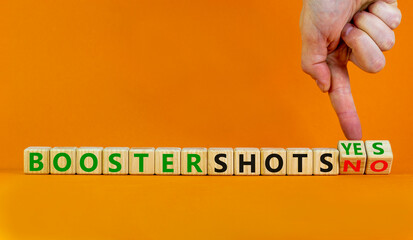 Covid-19 booster vaccine shots yes or no symbol. Doctor turns cubes changes words booster shots no to booster shots yes. Beautiful orange background copy space. Covid-19 booster vaccine shot concept.