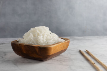 White shirataki noddle on white background with soy sauce . Konjac low carb pasta .