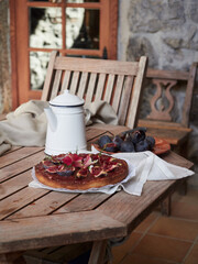 rustic wooden table ready to share teatime with fig tart