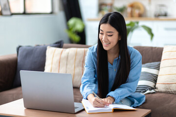 smiling asian looking laptop online education learning