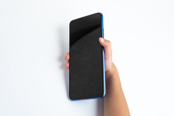 Child holding cellphone over white background