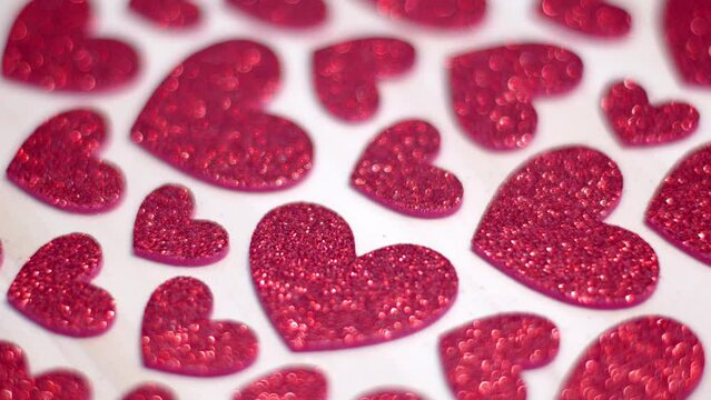 Red shiny valentine hearts on white background