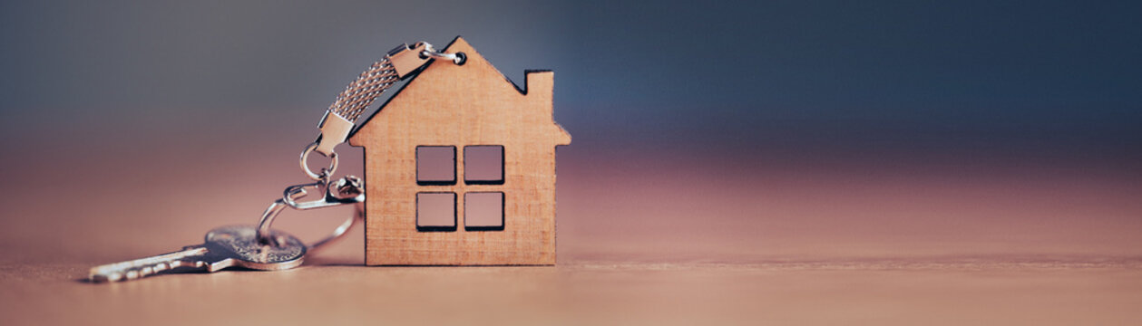 Keys from house on wooden background