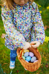 Little girl playing egg hunt on Easter