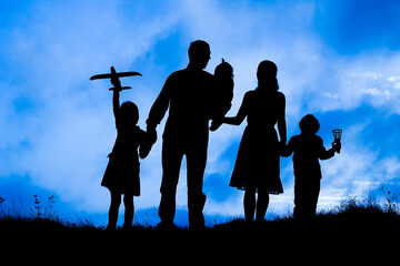 happy family by the sea on nature silhouette background
