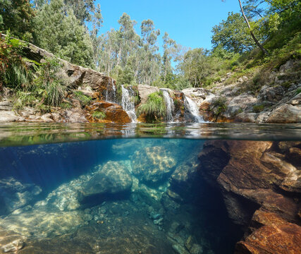 Wild river with small waterfall seen from water surface, split level view over and underwater, Spain, Galicia, Pozas de Bugalleira