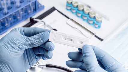 Covid test antigen coronavirus kit. Doctor holding rapid covid medical test. Laboratory hospital lab background. COVID-19 virus disease test, Coronavirus crisis.
