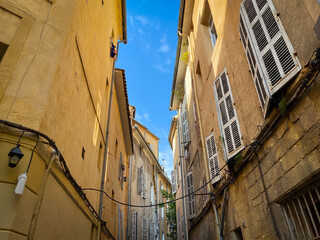 Typical colorful buildings of an old city street of Aix en Provence, France