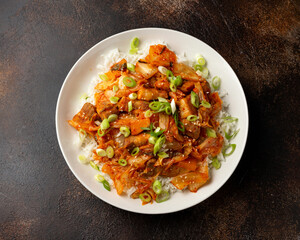 Korean Stir Fried pork belly kimchi with rice and spring onion. Asian food style