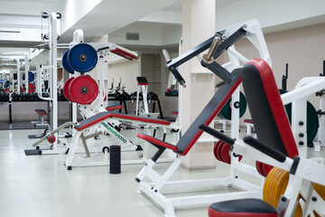 Fototapeta na wymiar gym modern fitness center room. empty hall with simulators on different muscles. no people