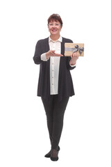 Mature brunette woman holding birthday gift over isolated white background