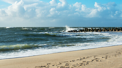 Storm on the North Sea, waves hitting the breakwater concrete tetrapods on the beach, Sylt, Germany