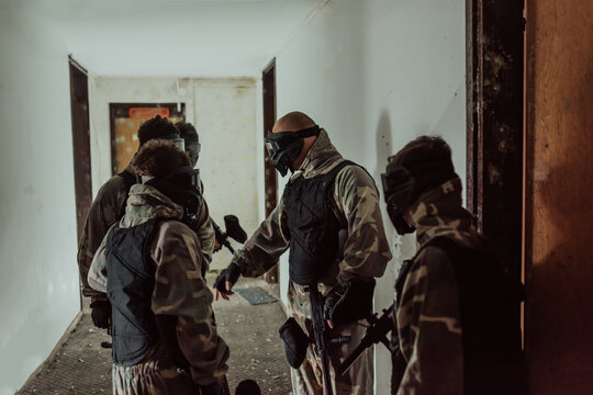 Photo of a paintball team in action with professional equipment.Selective focus