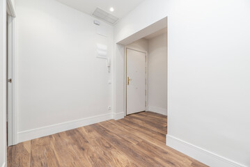 Entrance to a newly renovated residential home with chestnut wood flooring, high skirting board and...