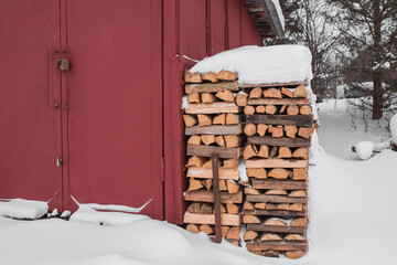 Firewood stacked in piles in winter.