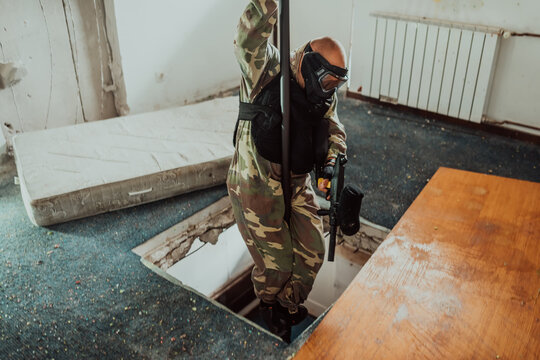 Photo of a paintball player in action with professional equipment.Selective focus