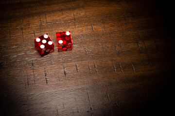 Professional casino-style dice on a wooden table with room for copy. 