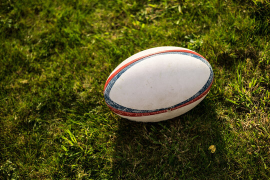Rugby  ball , Gilbert ,on sports field with green grass for the game of rugby. Focus on ball, sports base at background.oval,rugby team,try,rugby ball,grass,ball,rugby,team sport,sport,team sports,six