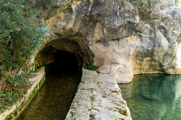 concrete artificial rill under the rock in a mountainous area