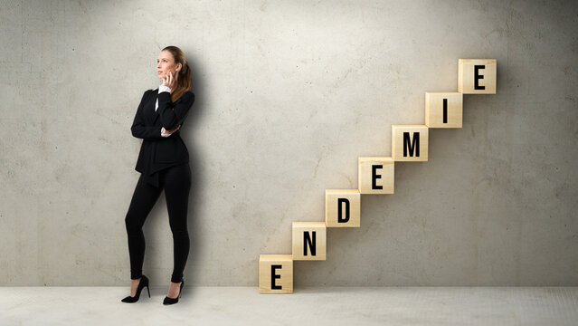 thinking businesswoman standing in front of cubes forming a stair with German message for ENDEMIC