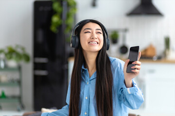 Happy carefree dancing fun home young woman