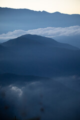 Blue beautiful mountains Ands in Colombia Latin America with clouds and fogs in the early morning, landscape