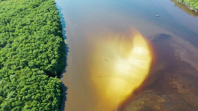 Panning wide view of peaceful darm river at coastal city of Itanhaem Sao Paulo Brazil. South coast of state of Sao Paulo. Tropical scenery. Travel destinations. Popular tourism landmark.