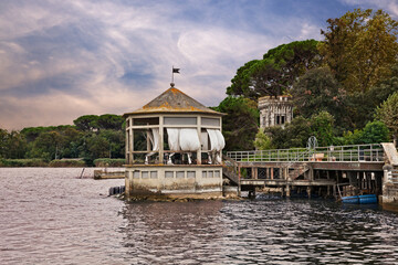 Torre del Lago Puccini, Viareggio, Lucca, Tuscany, Italy: landscape of  the Lake of Massaciuccoli with a gazebo and the tower of an ancient villa in the pine forest - obrazy, fototapety, plakaty