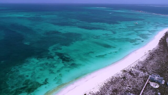 Panning wide landscape of tropical island with turquoise water. Caribbean sea. Travel destination. Los Roques Venezuela. Romantic landscape.