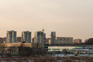 Fototapeta na wymiar Production workshops on the background of the city. Moskovsky district Kommunarka