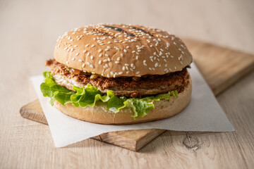 Delicious burger on a wooden board