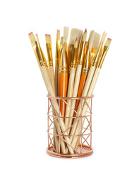 Fototapeta premium Set of paintbrushes in holder on white background